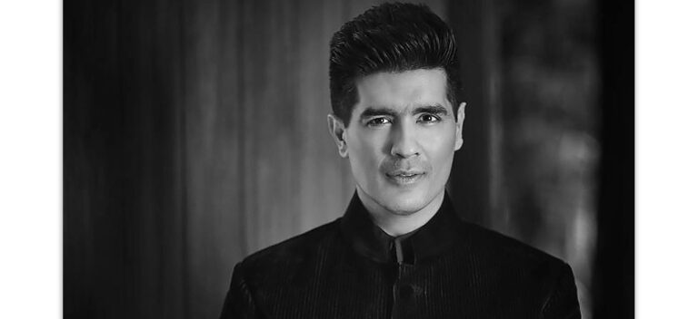 Manish Malhotra in his couture studio showcasing creativity and fashion brand success.