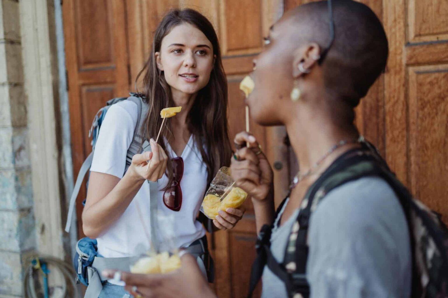 Travelers enjoying local street snacks, representing the global snack tourism trend