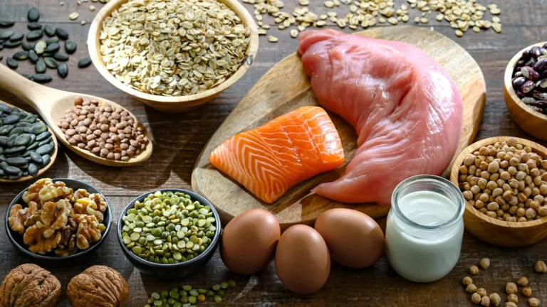 A variety of high-protein foods including eggs, nuts, yogurt, and legumes, showing easy ways to increase daily protein intake for health, fitness, and muscle building.